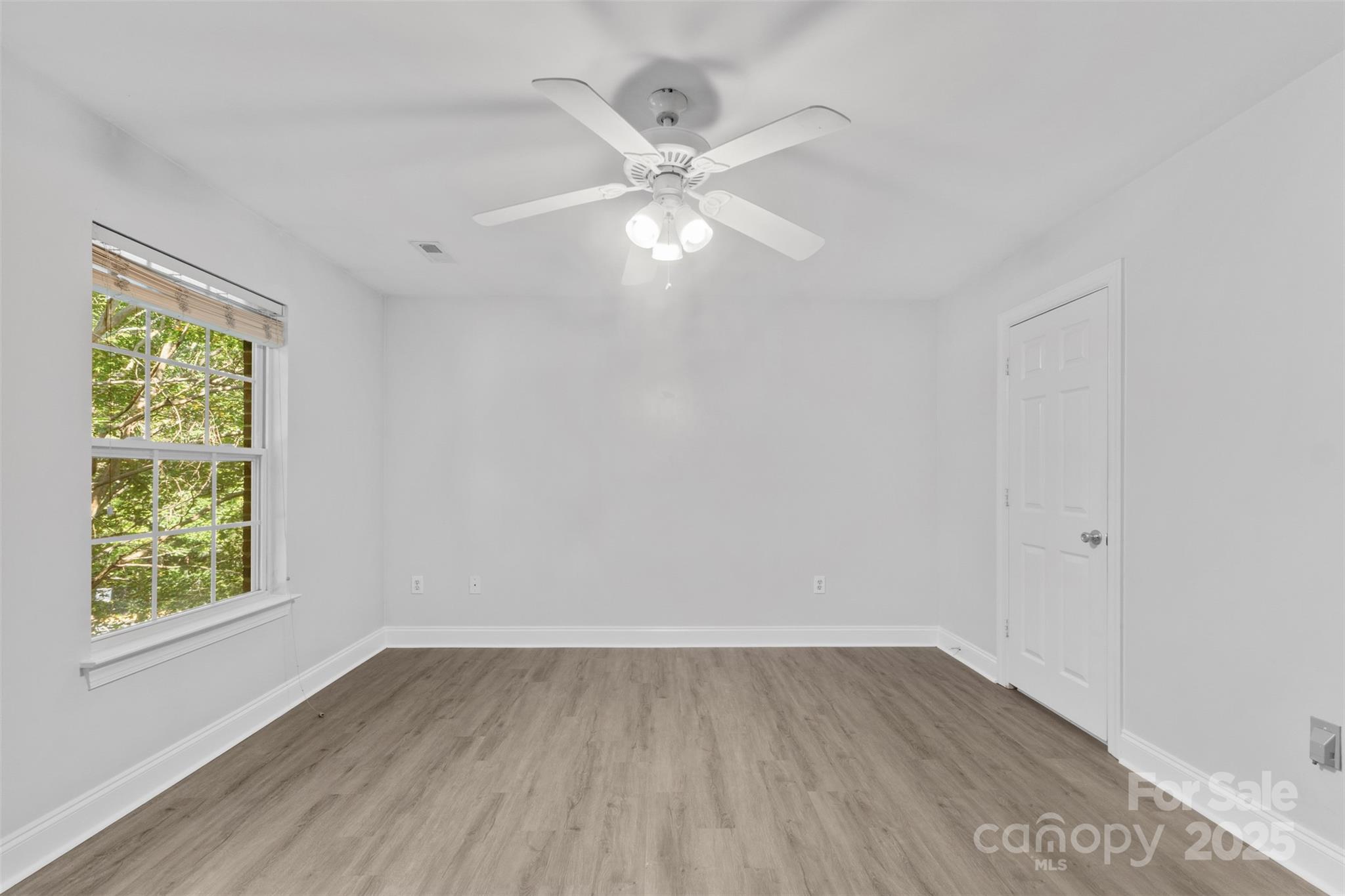 2476 Ryerson Court Charlotte, NC 28213 - Photo 27 of 30 wooden floor in an empty room with a window