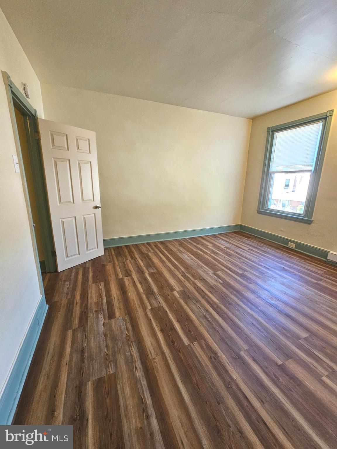 5515 North Fairhill Street Philadelphia, PA 19120 - Photo 3 of 12 a view of an empty room with wooden floor and a window