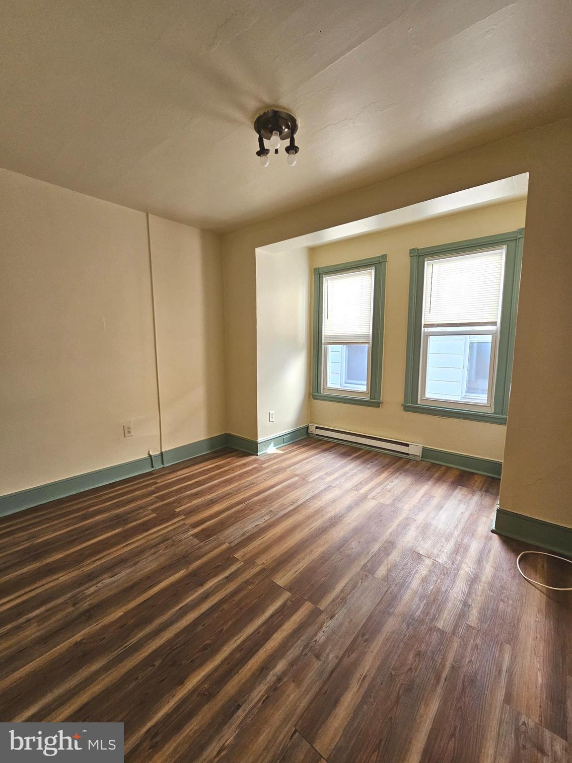5515 North Fairhill Street Philadelphia, PA 19120 - Photo 4 of 12 an empty room with wooden floor and windows