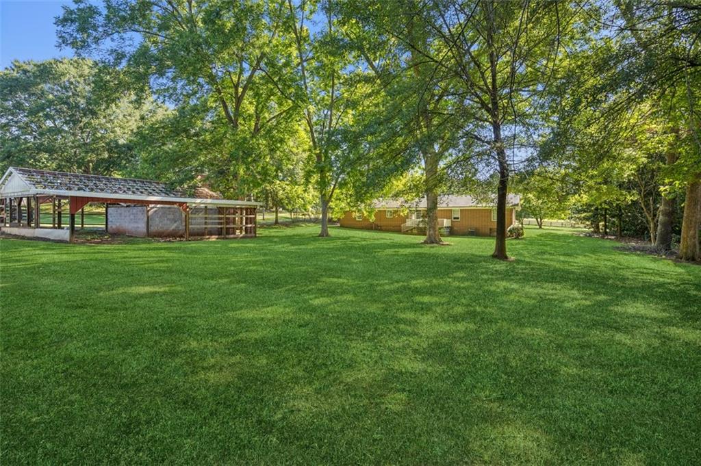 13890 Cowart Road Alpharetta, GA 30004 - Photo 13 of 33 a view of a house with a big yard
