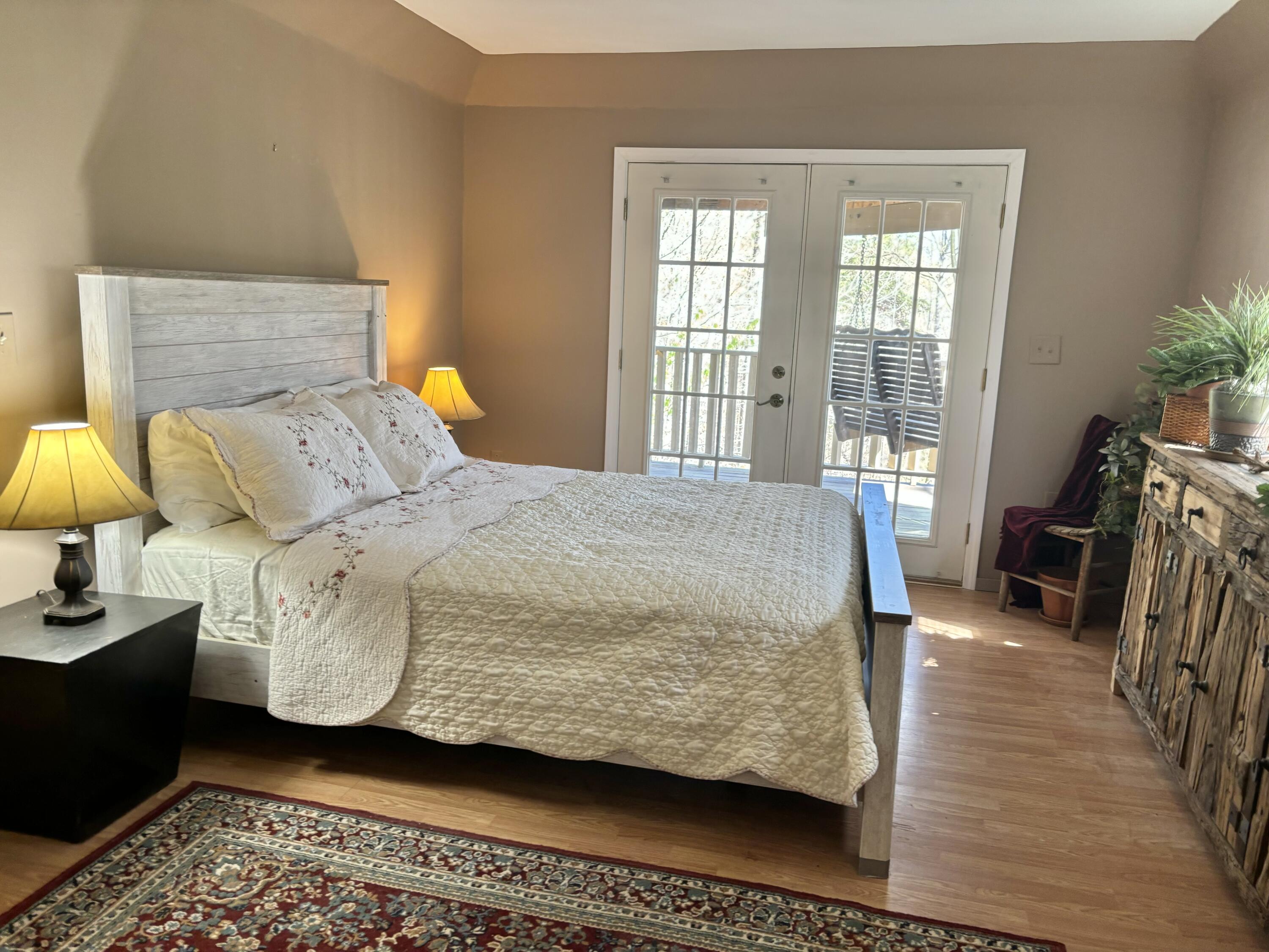 980 Power Dam Road Rocky Mount, VA 24151 - Photo 16 of 55 a bedroom with a bed a chandelier and a dresser