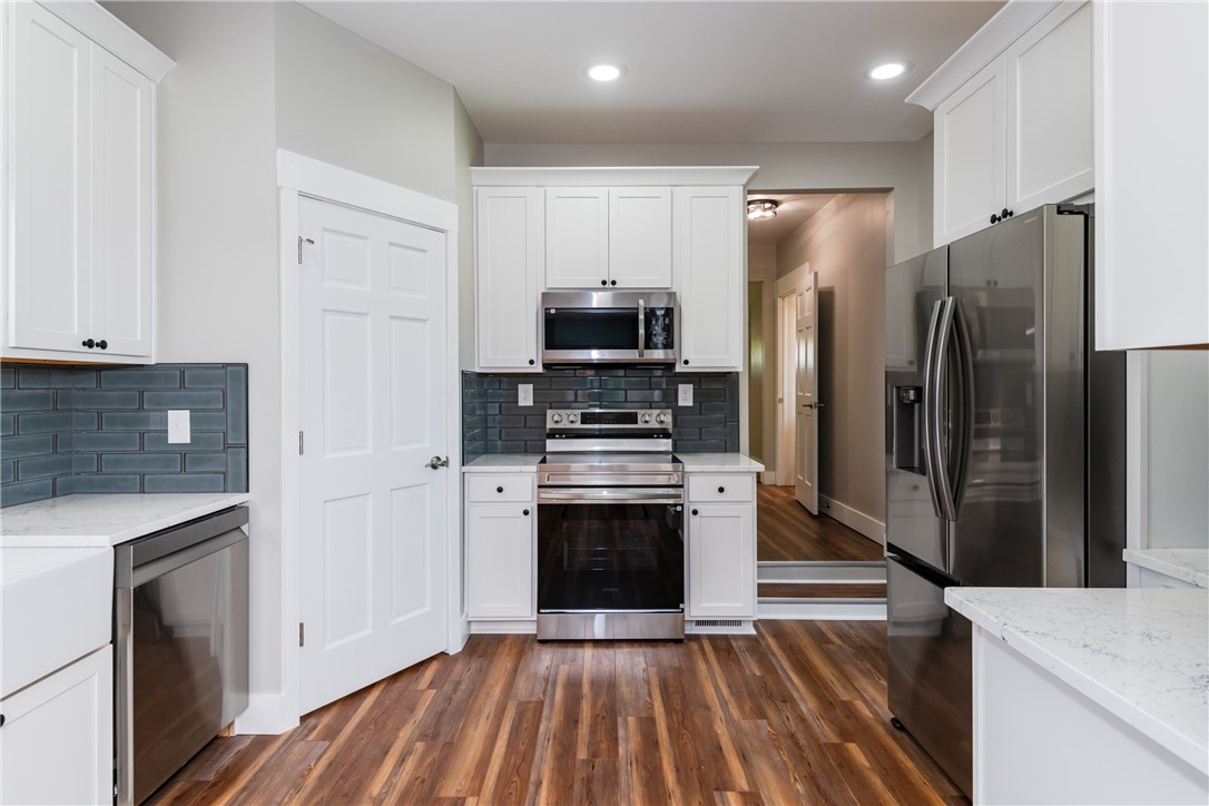 1217 Jasper Road Xenia, OH 45385 - Photo 21 of 62 This kitchen features sleek stainless steel appliances, ample cabinetry, and rich lvp flooring.