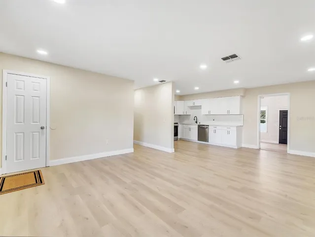 a view of a kitchen with a sink and a refrigerator
