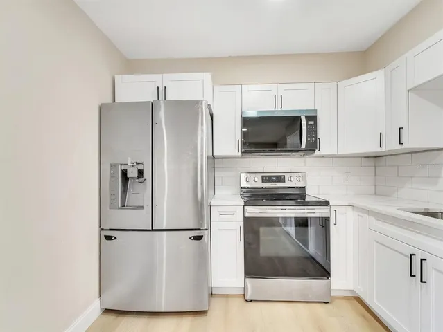 a kitchen with a refrigerator stove and microwave