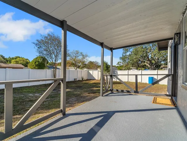 a view of a balcony with floor to ceiling windows with wooden floor