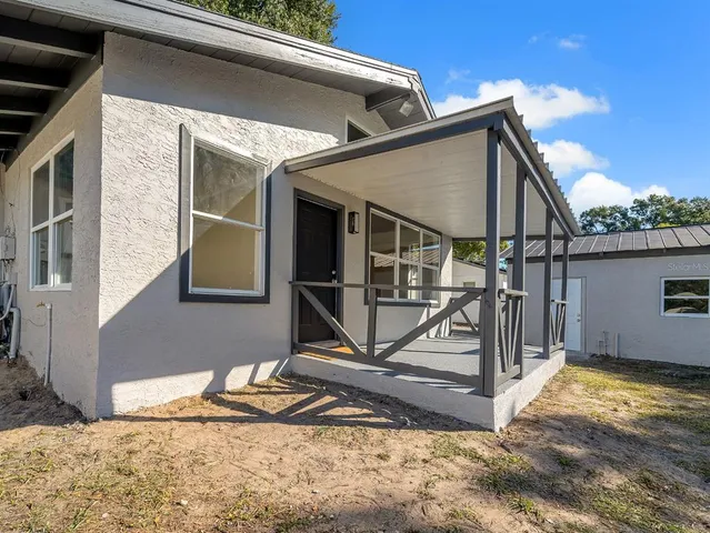a view of a house with a wooden fence
