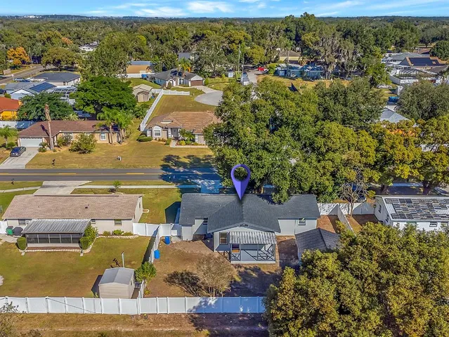 an aerial view of a house with a swimming pool