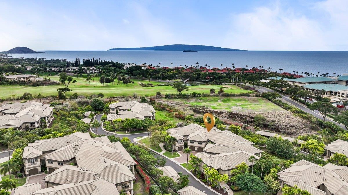 an aerial view of a city with lots of residential buildings and mountain view in back