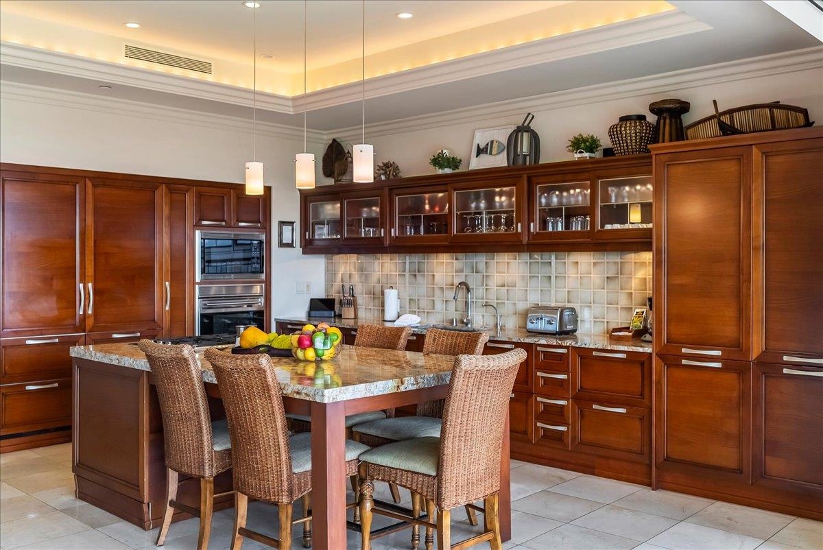 21 Kiloa Street, Unit 4 Kihei, HI 96753 - Photo 11 of 50 a open kitchen with stainless steel appliances granite countertop a dining table chairs cabinets and a sink