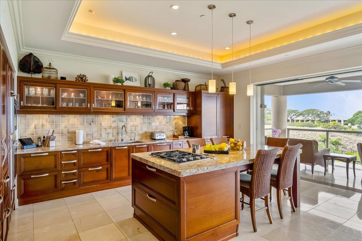 21 Kiloa Street, Unit 4 Kihei, HI 96753 - Photo 12 of 50 a kitchen that has a lot of cabinets in it