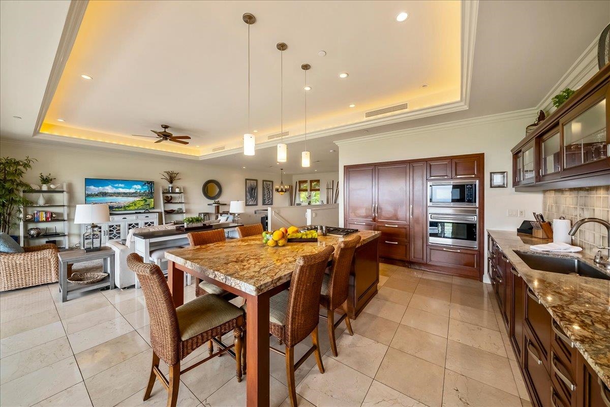 21 Kiloa Street, Unit 4 Kihei, HI 96753 - Photo 14 of 50 a large kitchen with a table and chairs