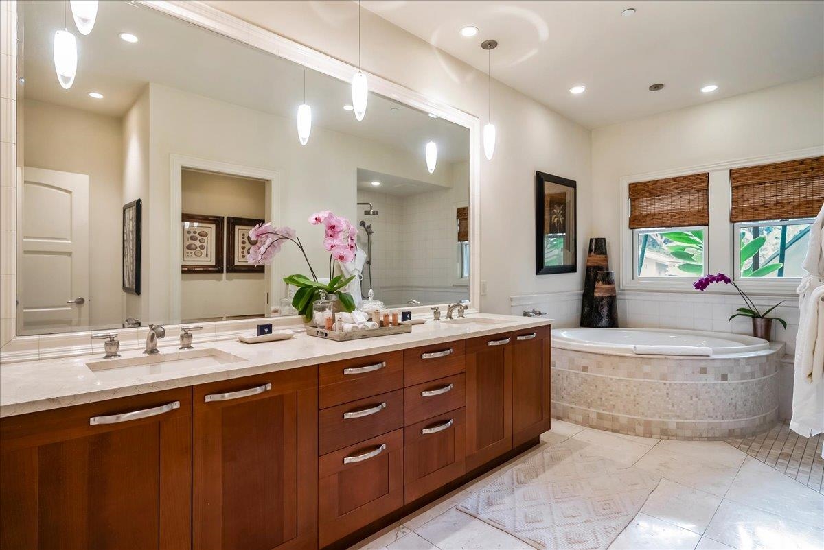 21 Kiloa Street, Unit 4 Kihei, HI 96753 - Photo 30 of 50 a spacious bathroom with a double vanity sink a large mirror and a bathtub