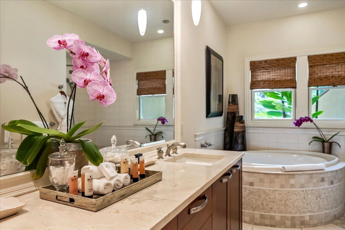 21 Kiloa Street, Unit 4 Kihei, HI 96753 - Photo 31 of 50 a bathroom with a granite countertop sink a mirror and a window