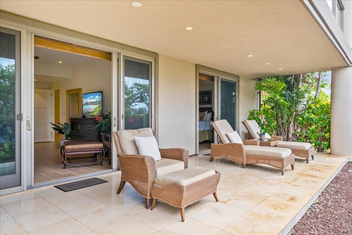 21 Kiloa Street, Unit 4 Kihei, HI 96753 - Photo 35 of 50 a living room with furniture and a large window