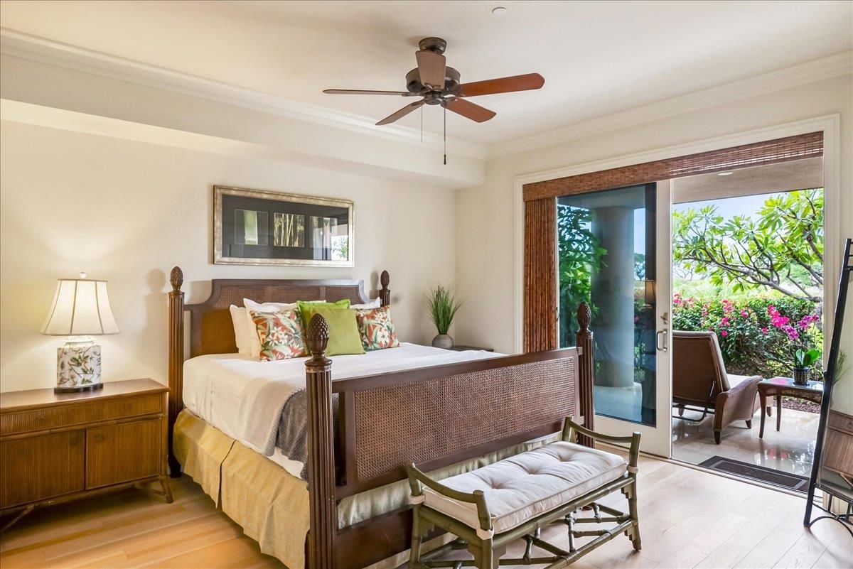 21 Kiloa Street, Unit 4 Kihei, HI 96753 - Photo 40 of 50 a bedroom with a bed a chandelier and a potted plant