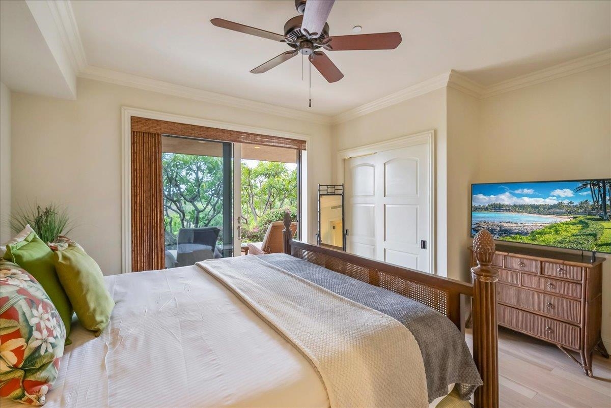 21 Kiloa Street, Unit 4 Kihei, HI 96753 - Photo 41 of 50 a bedroom with a bed and a flat tv screen on dresser