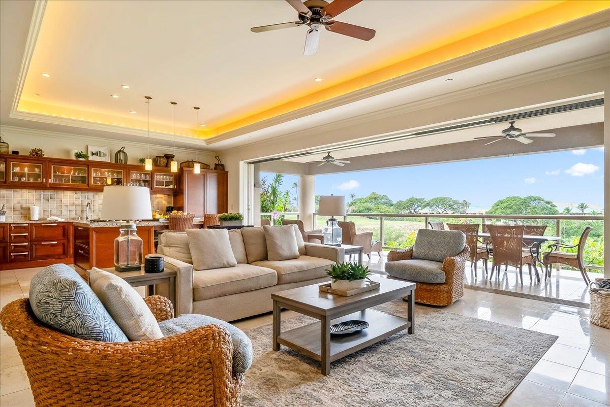 21 Kiloa Street, Unit 4 Kihei, HI 96753 - Photo 6 of 50 a living room with furniture a rug and a floor to ceiling window