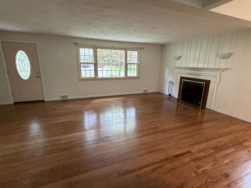 74 Birch Road Longmeadow, MA 01106 - Photo 10 of 38 an empty room with wooden floor fireplace and windows
