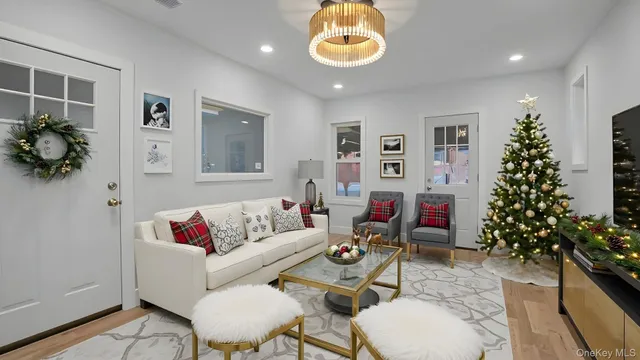 a living room with furniture and flowers