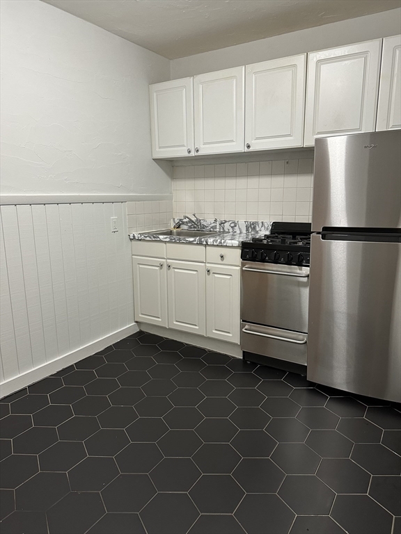 a kitchen with a sink a stove and refrigerator