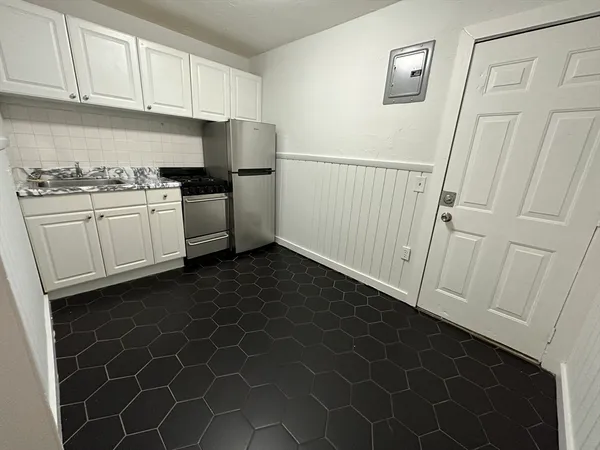 a kitchen with a sink a stove and a refrigerator