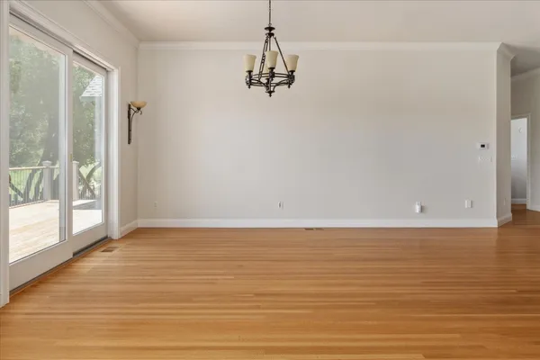 a view of a room with an empty space and a window