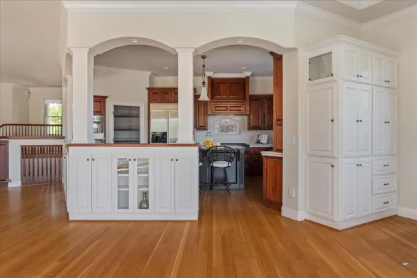 a kitchen with stainless steel appliances a stove window and cabinets