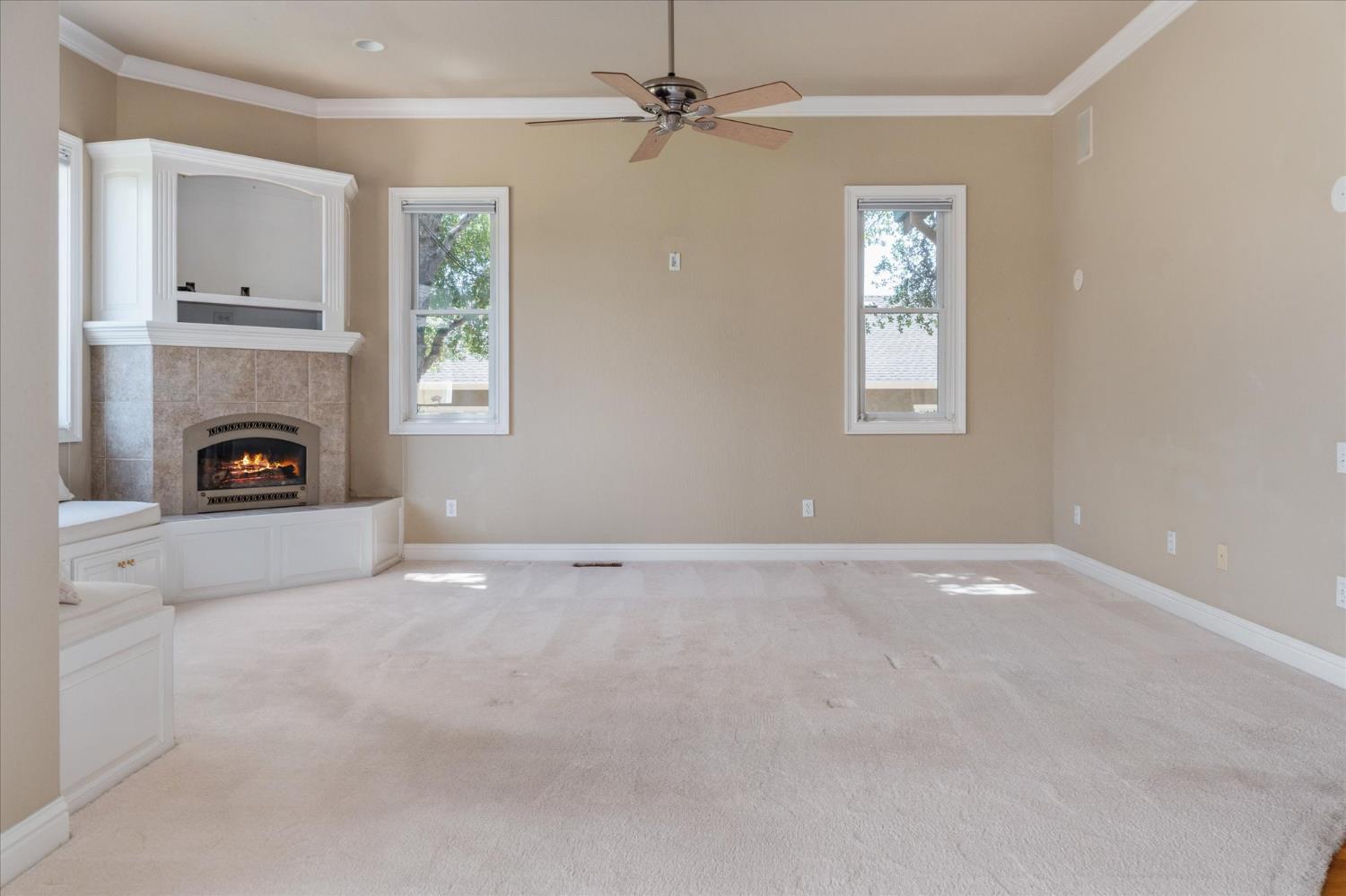 643 Miwuk Way Angels Camp, CA 95222 - Photo 19 of 55 an empty room with windows and fireplace