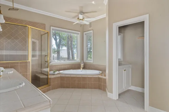 a spacious bathroom with a tub shower and sink