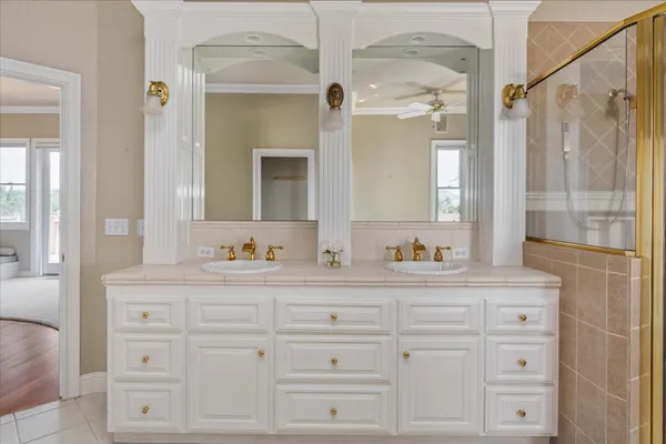 a bathroom with a granite countertop sink and a window