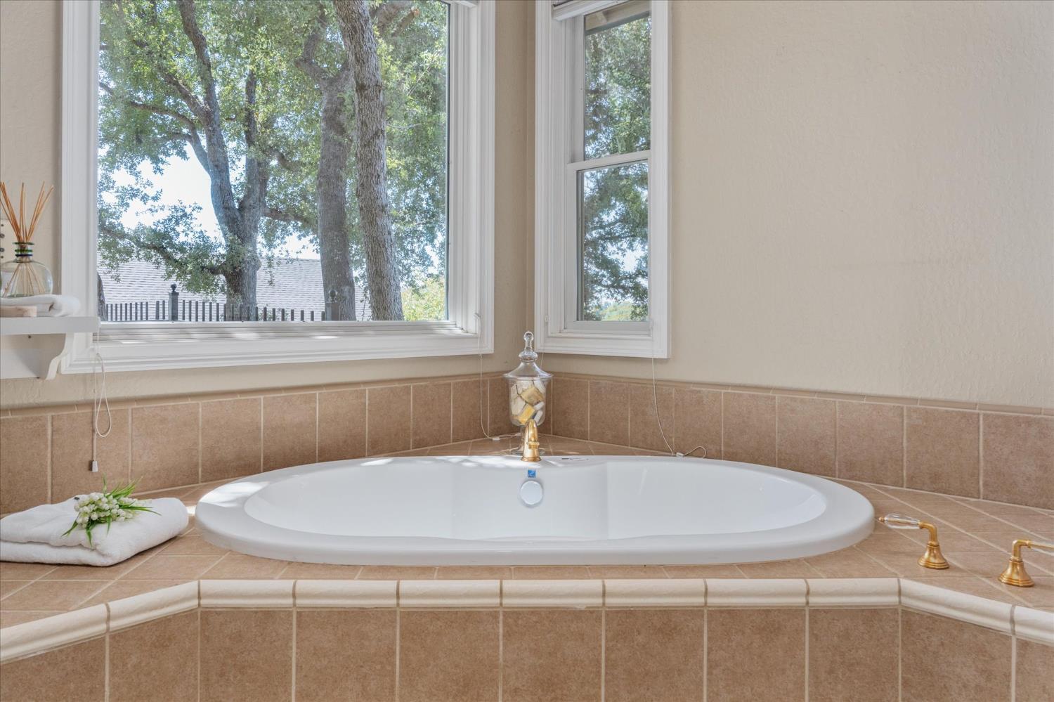 643 Miwuk Way Angels Camp, CA 95222 - Photo 23 of 55 a bathroom with a granite countertop sink and a window