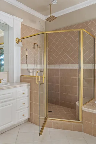 a bathroom with a shower and a sink a mirror