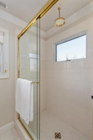 a bathroom with a shower and a mirror
