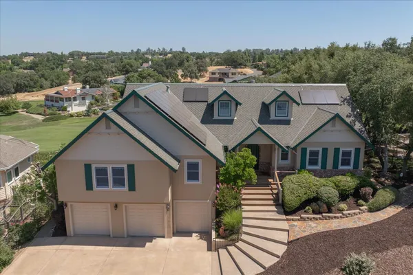 a aerial view of a house with a yard