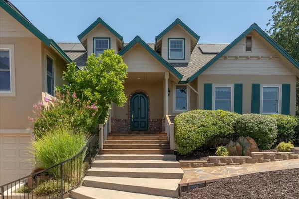 a front view of a house with garden