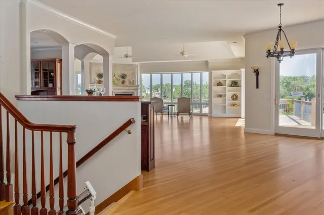 a view of a living room with hardwood floor and furniture