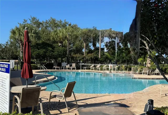 a view of a lake with a table and chairs