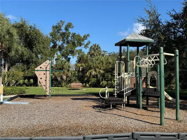 a front view of a house with garden and sitting area