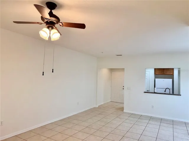 a view of empty room with ceiling fan