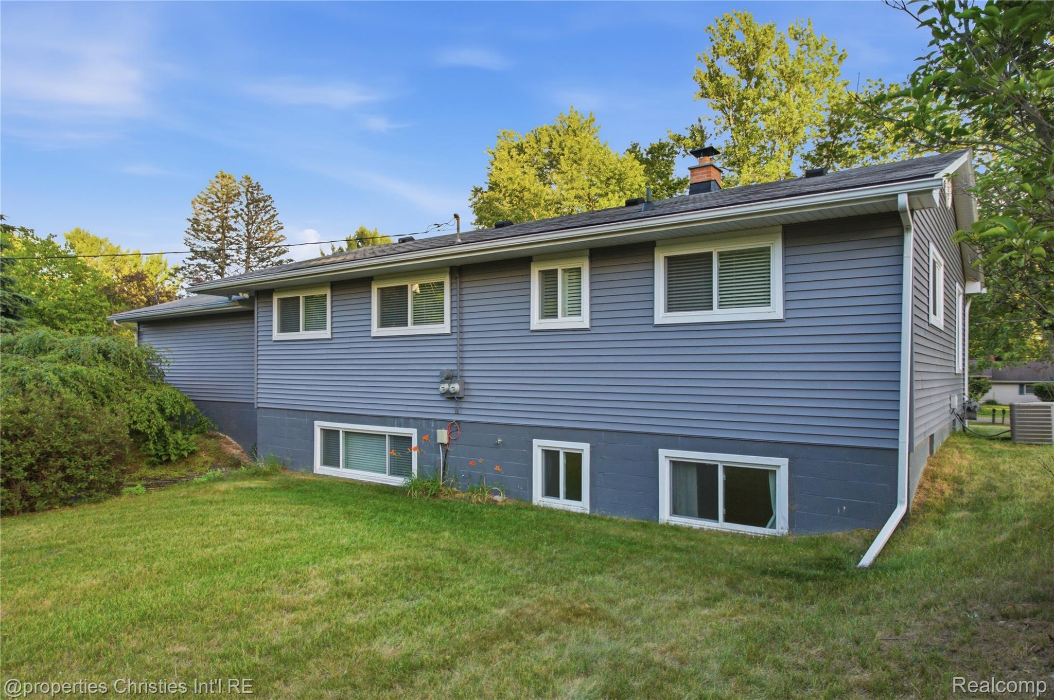 3851 Judd Road Milan, MI 48160 - Photo 38 of 41 Exterior with blue horizontal siding and white trim