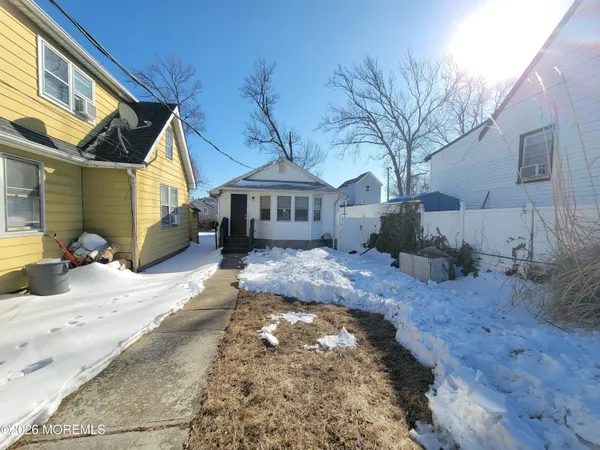 a view of a yard with a house and a tree