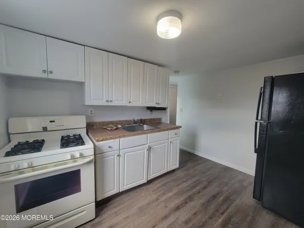 a kitchen with a stove cabinets and a refrigerator