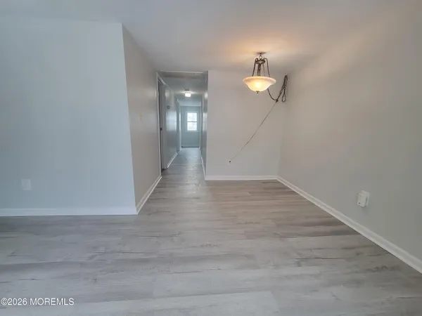 a view of a room with wooden floor