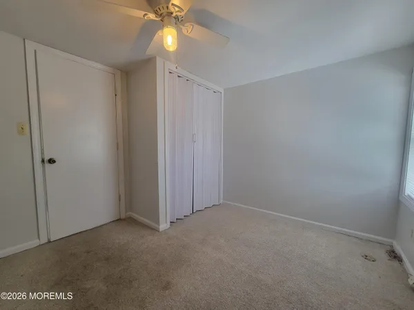 a view of an empty room with a fan
