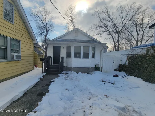a view of a house with a yard covered in snow