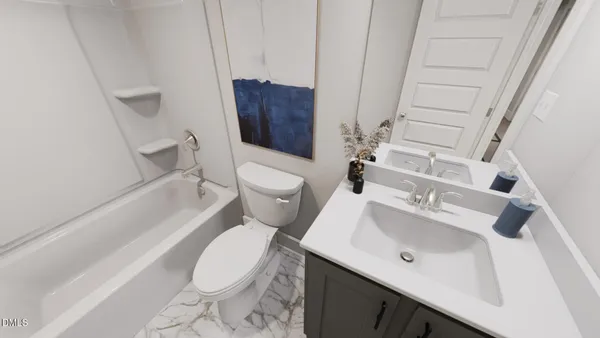 a white toilet sitting next to a bathroom sink