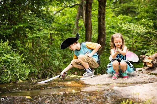 a backyard of a house with table and chairs