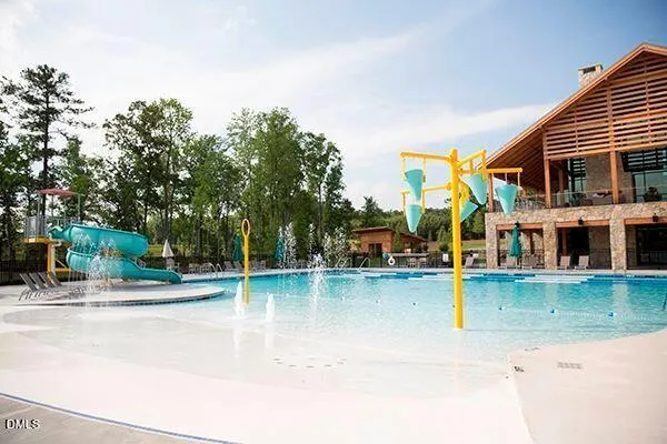 a swimming pool with outdoor seating and yard