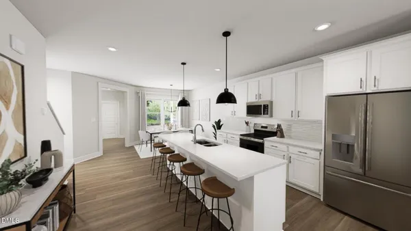 a kitchen with stainless steel appliances a table chairs refrigerator and microwave