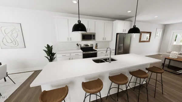 a kitchen with stainless steel appliances a dining table chairs and a refrigerator